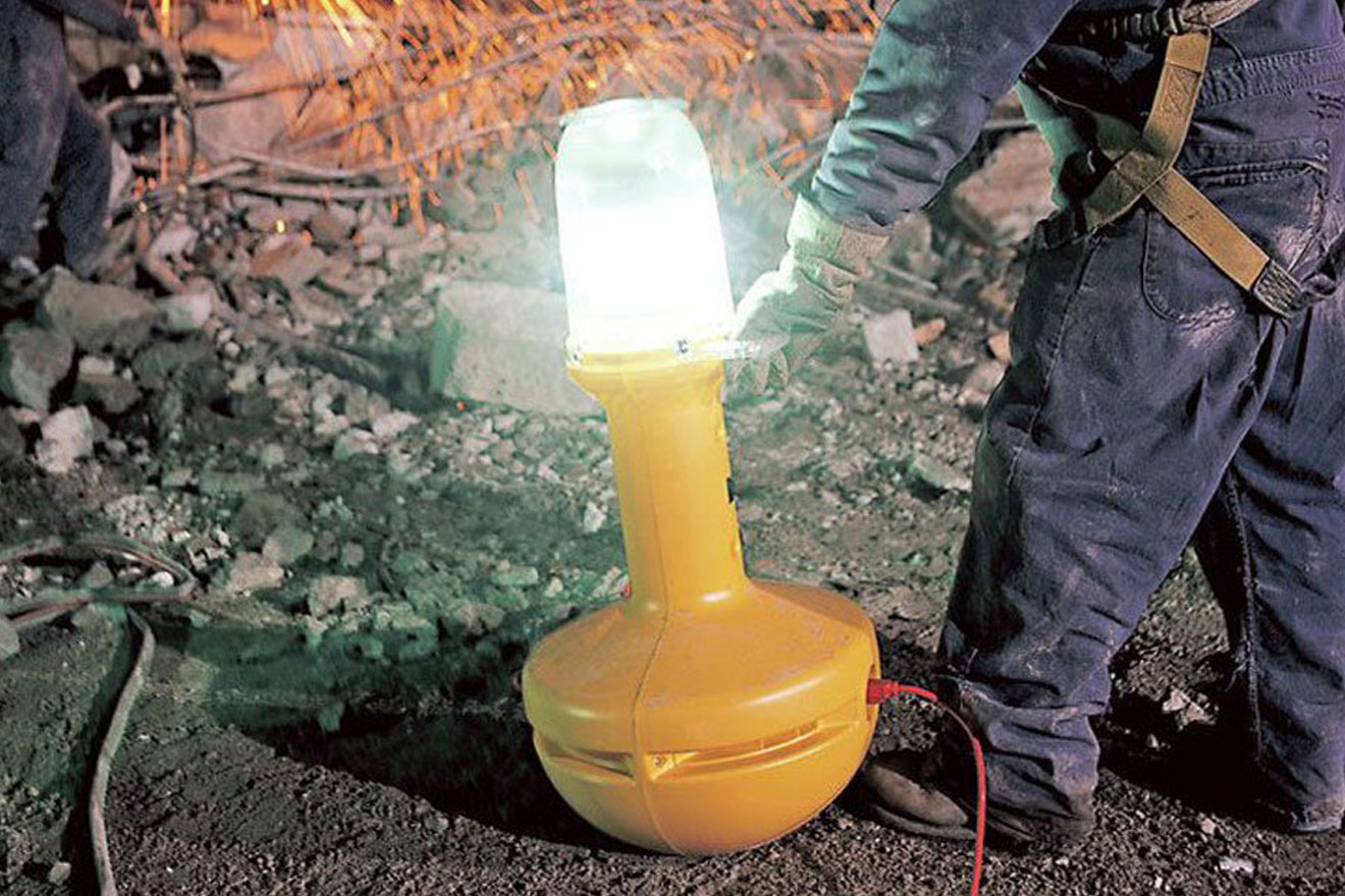 a photo of a work light being set up on a jobsite at night