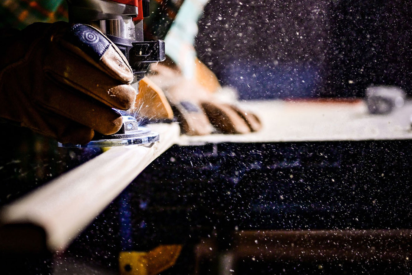 a photo showing a worker cutting a piece of wood for a staircase